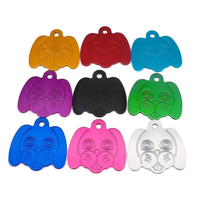 Wholesale pack of 100 personalized dog head pattern pet ID tags in various colors, showcasing their reflective and durable aluminum design.